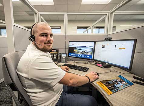 Man working at a computer, facing the camera