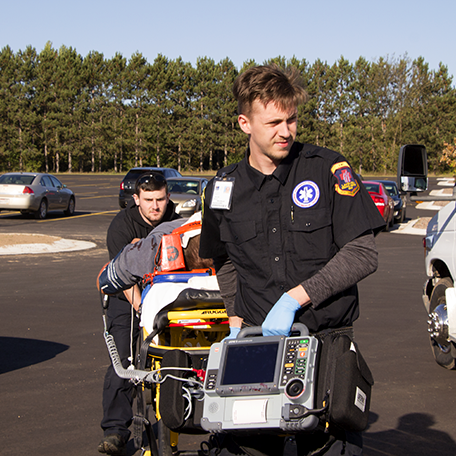 EMT student carrying a stretcher