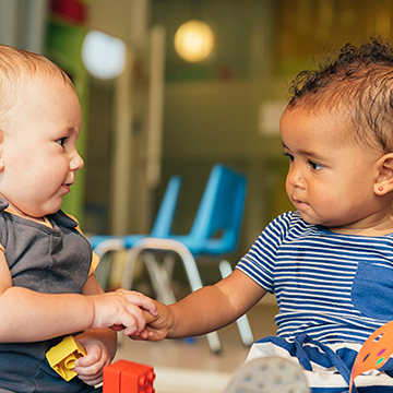 Two babies playing together