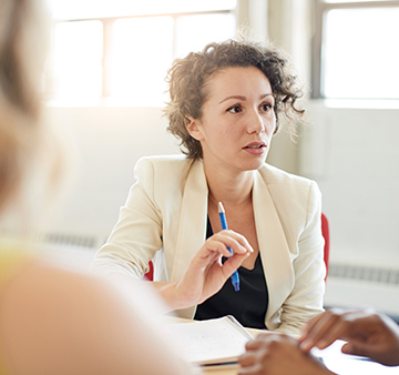 A business professional in a group meeting