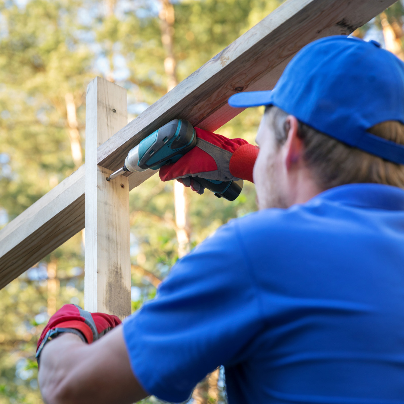 A construction worker working on the framing of a house