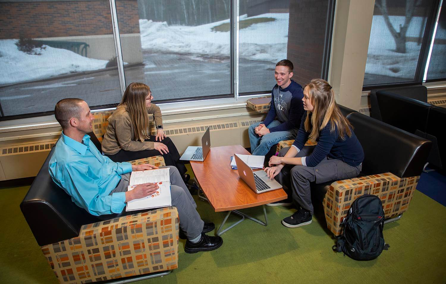 Four students hanging out in a common area