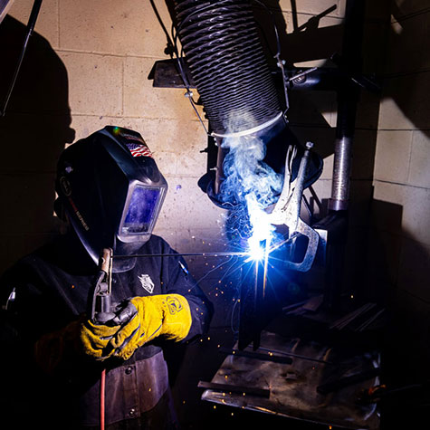 A student practicing welding skills