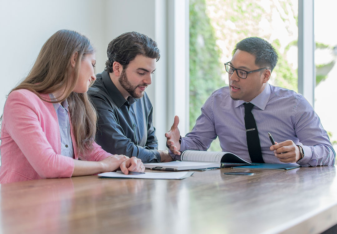 A group of businessmen and businesswoman meets together