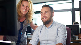 Student in classroom at the computer with teacher