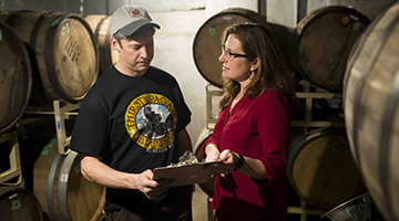 Business partners at work looking at a clipboard