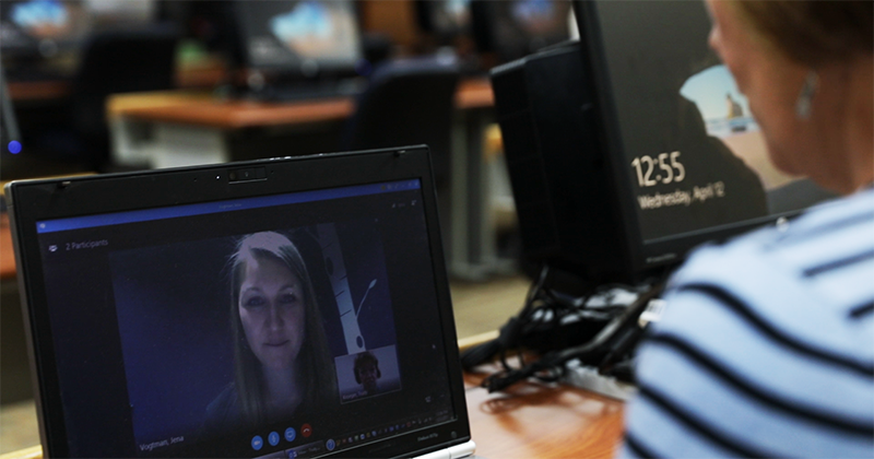 Instructor working with a student on the computer