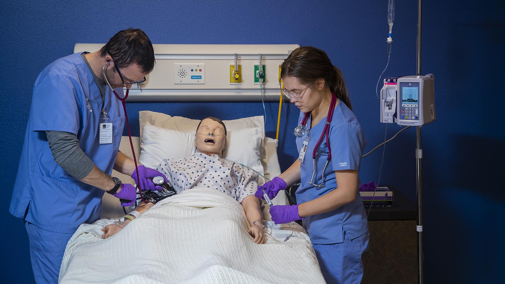 Two nursing student working together on a simulated patient