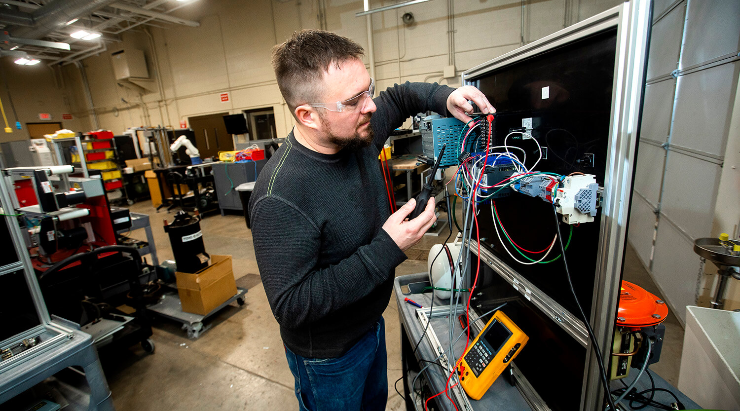 Student working with technology in the automation lab