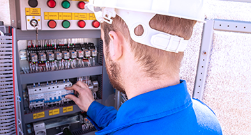 A worker doing maintenance on a machine