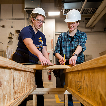 Two female students working on construction project