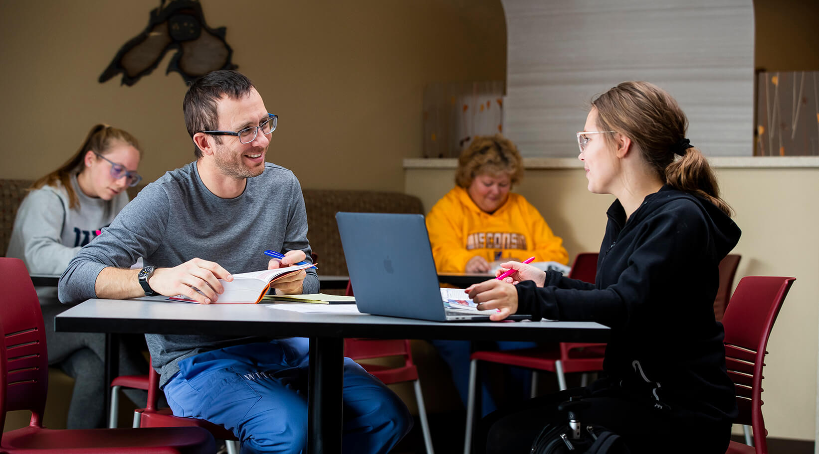 Two students laughing and studying