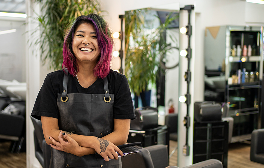 Cosmetology student smiling at camera in salon
