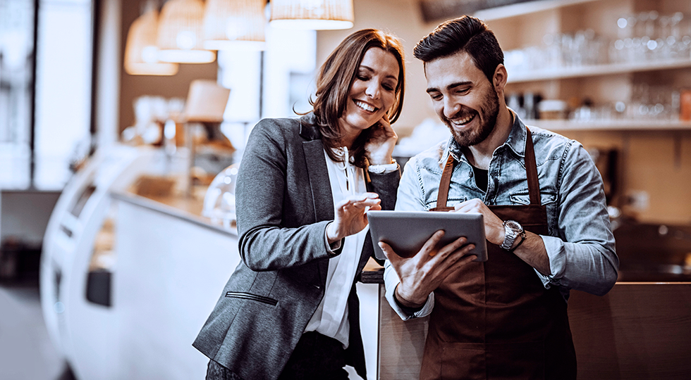 Two retail workers looking at a menu