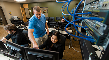 An instructor helping a student at a computer