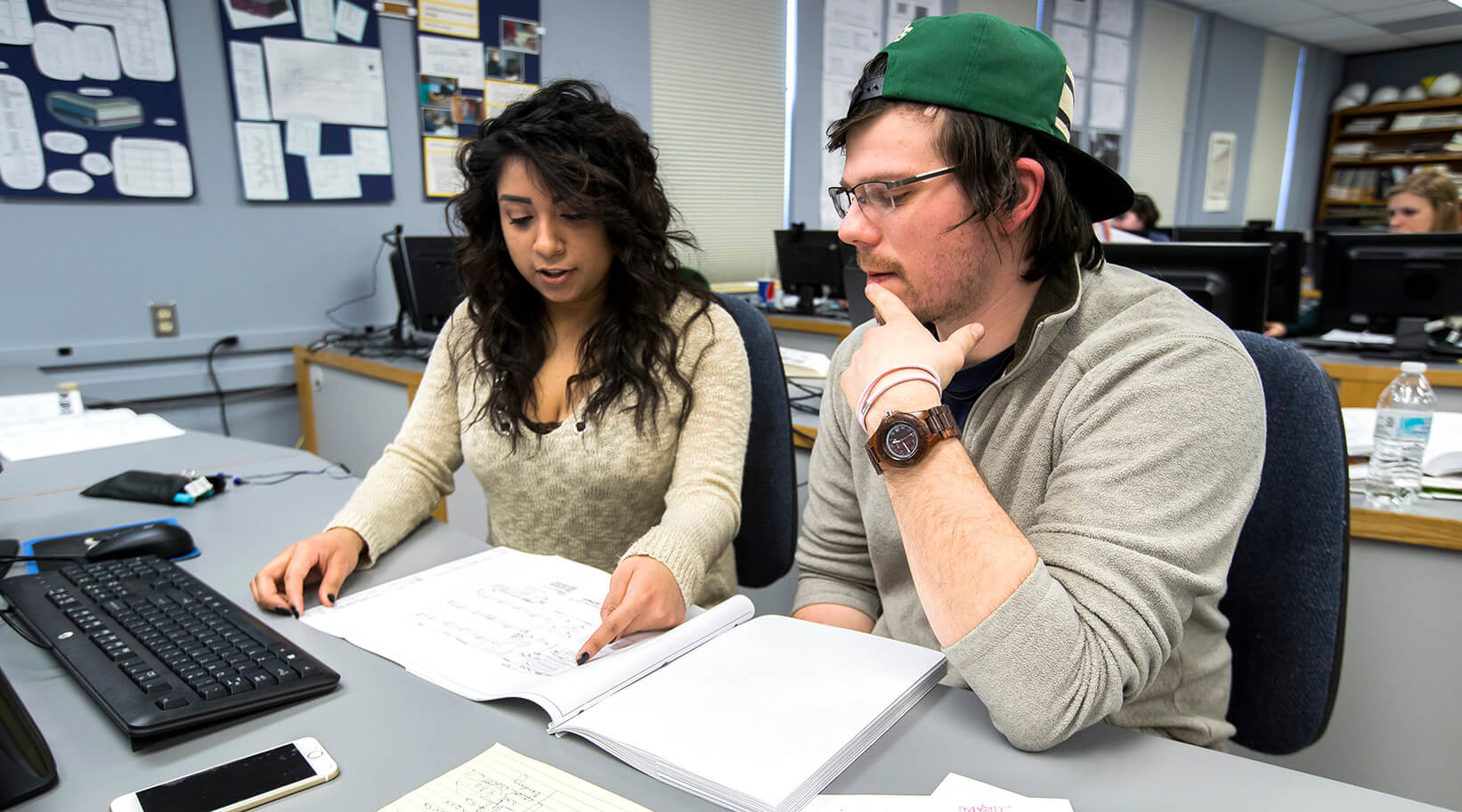 Two students looking at notes