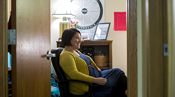 A counselor sitting in an office chair