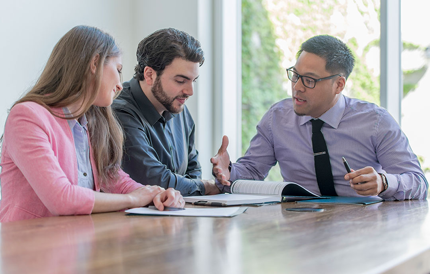 A group of FINANCIAL businessmen and businesswoman meets together