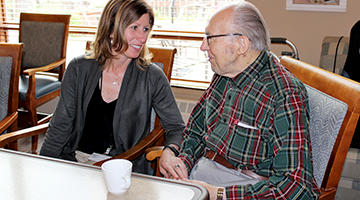 Director of an assisted living facility talking with a resident