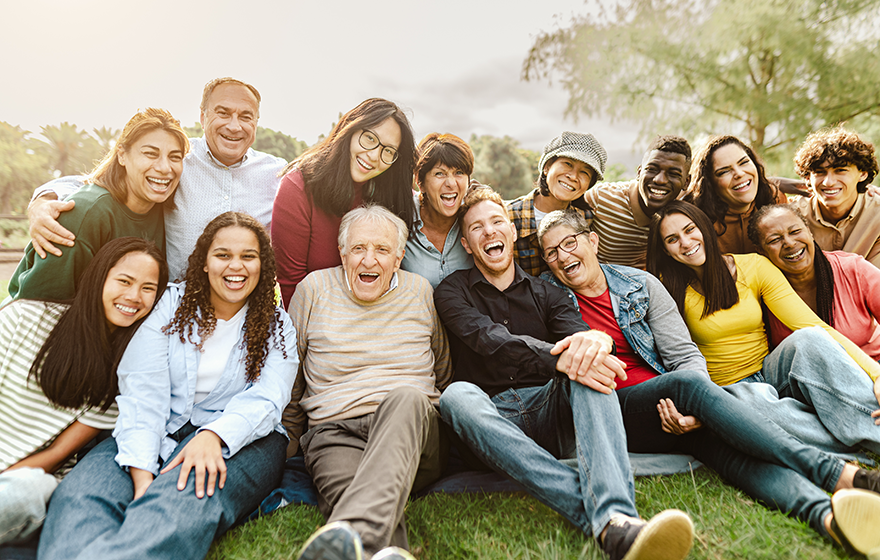 Multi-generational family posing for picture at a park