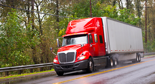 A semi-truck driving down a highway