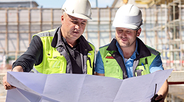 Construction workers looking over plans