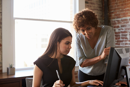 Two professionals working together in an office