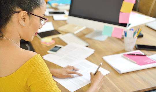 Business person at desk with post-it notes 