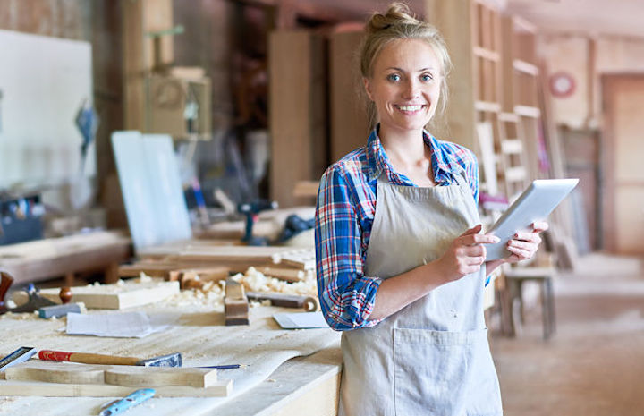 Woman using a tablet in her business workshop