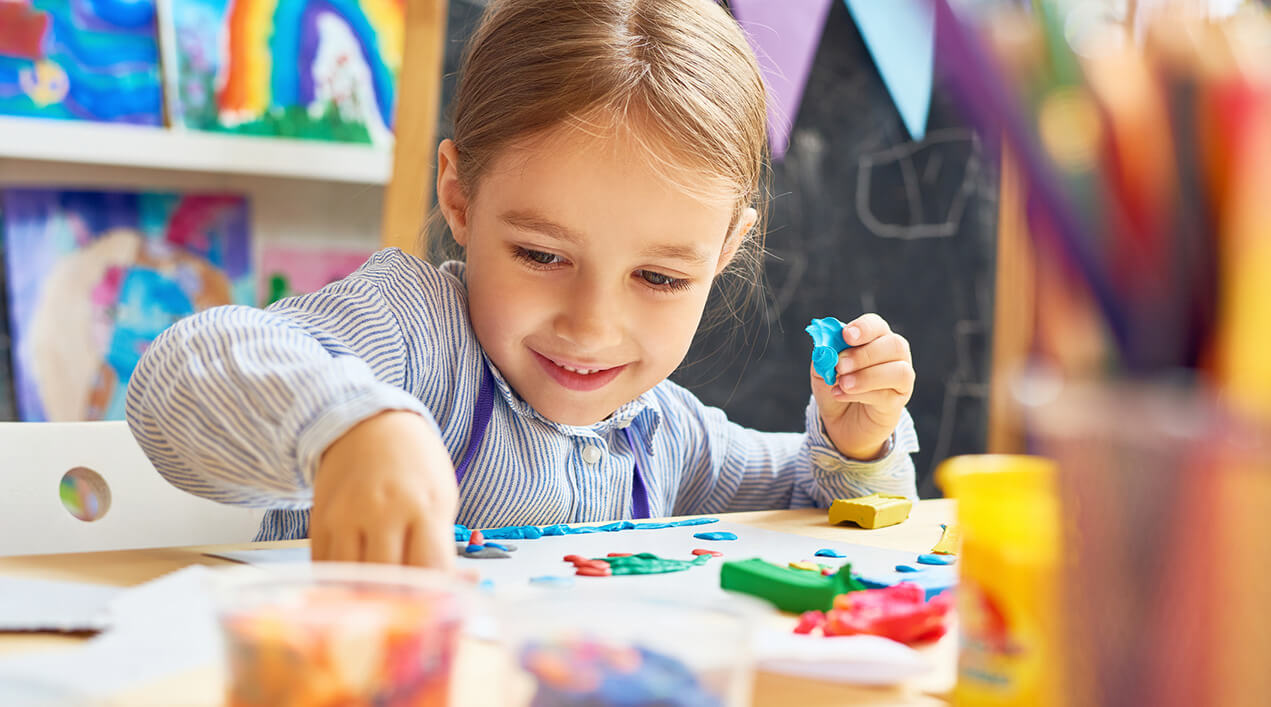 A preschool-aged kid doing an art project
