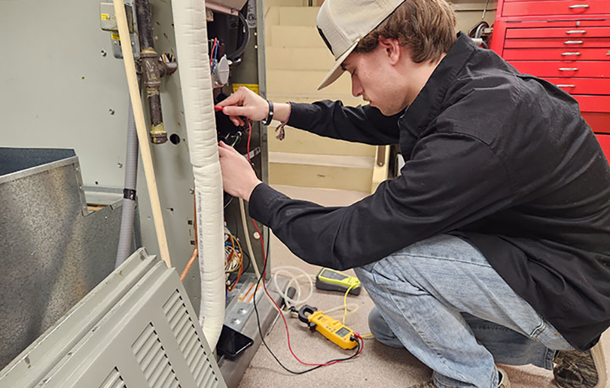 Students doing hands-on work in the HVAC industry