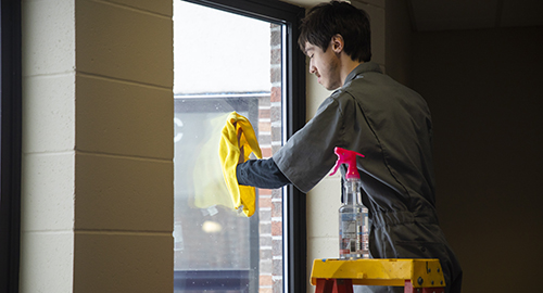 A student cleaning the windodws