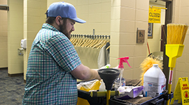 A student with cleaning supplies