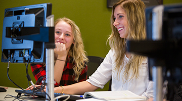 Two students looking at a computer