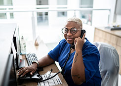 Female taking a call at her desk - medical field