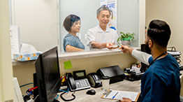 A medical administrative professional working with customers
