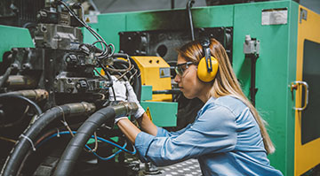 Professional technical worker woman working with production line machine