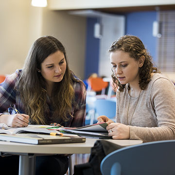 Two students studying at a table