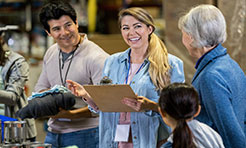 Mid Adult Woman Enjoys Leading Food Bank Volunteers