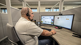 An office employee talking on the phone at desk