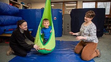 Students helping a child