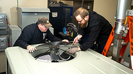 Two students doing hands-on work in the lab