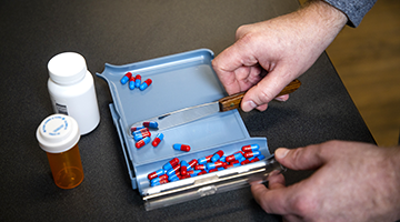 A pharmacy technician counting pills