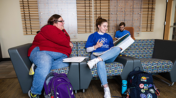 Student sitting in a group smiling