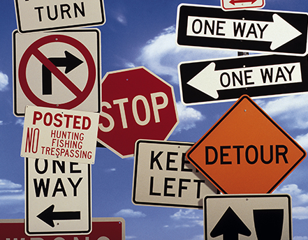 A variety of traffic signs including stop, detour, one way, keep left, and no right turn.