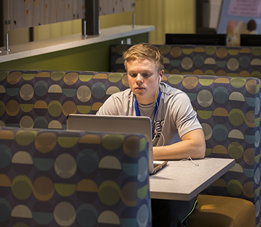 Young man studies at a booth at WITC