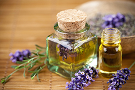 Glass jars with oil and fresh lavender plant