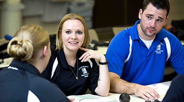 Student sitting in a group smiling