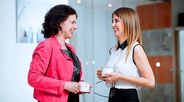 Two co-workers talking and laughing