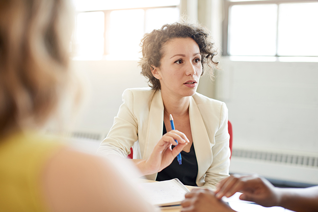 A business professional in a group meeting